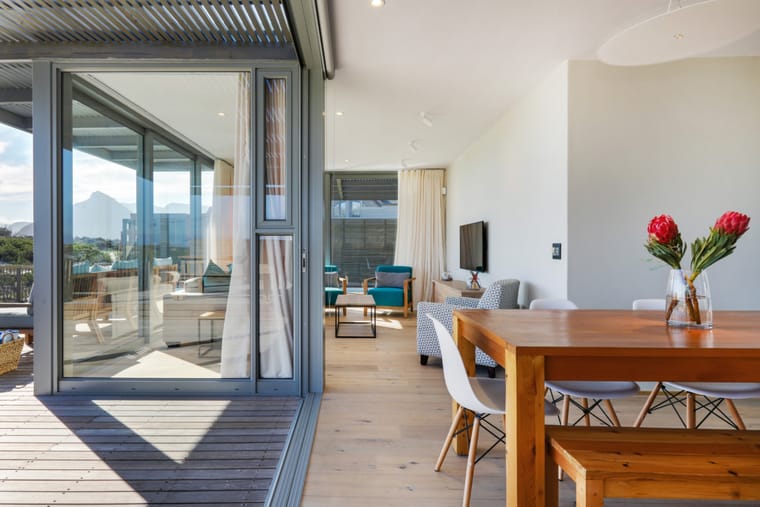 The dining table beside the doors to the deck