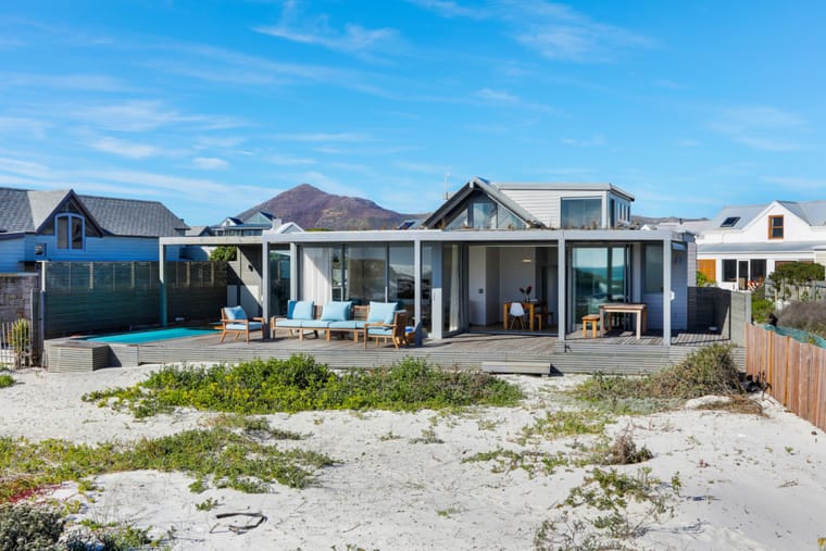 The house from the beach path, open to the deck and pool