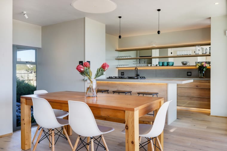 The open-plan kitchen with its island and the dining table