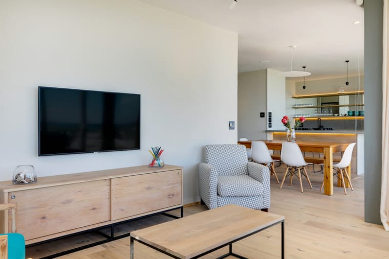 The living and dining areas seen together from the kitchen end