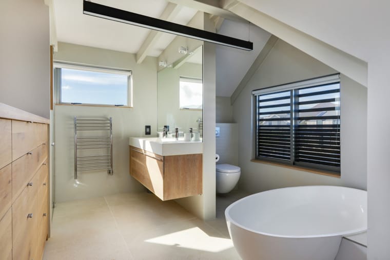 The master en-suite with a freestanding bath and twin basins