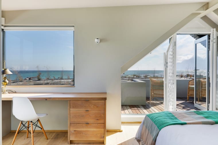 The upstairs master bedroom with the desk and the view over the ocean