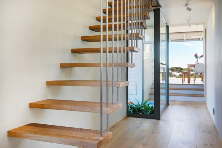 The open oak staircase leading up to the master suite