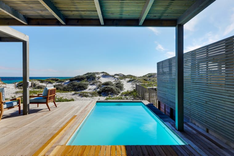 The pool on the deck with loungers and the ocean beyond